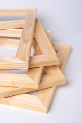 A stack of wooden stretchers for stretching the canvas lies on a white background.