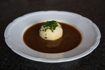 cooking at home and ready to eat, a greaves dumpling in brown sauce from roast venison and chives