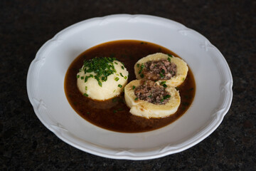 cooking at home and ready to eat, greaves dumpling in brown sauce from a roasted venison and chives