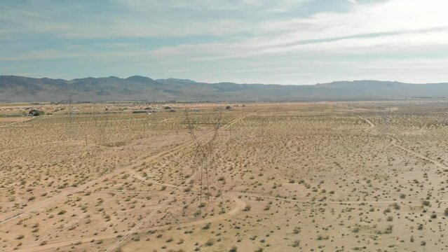 Aerial view of the Mojave Desert, electrical transmission towers and the Tehachapi Mountains on an overcast day