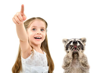 Portrait of cute cheerful girl pointing finger up and a surprised raccoon, isolated on white...