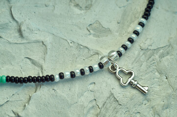 Handmade beadwork, beading as a hobby. Decorations made with your own hands on the background of various flowers