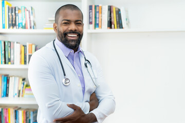 Laughing african american doctor with beard and stethoscope