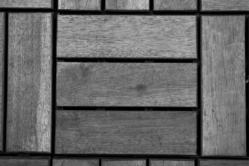 evocative black and white texture image of square shaped wooden dowels for flooring 
