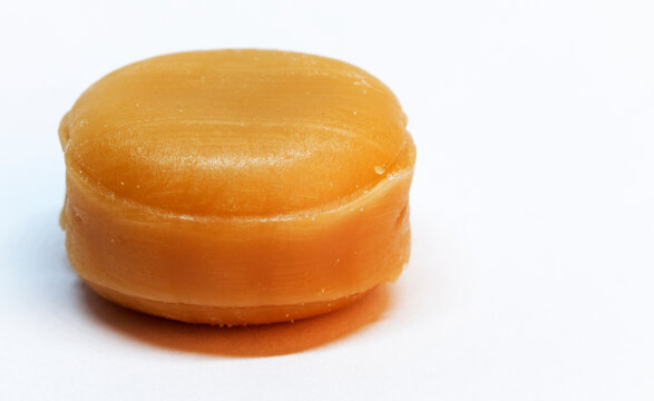 caramel candy without paper on white background