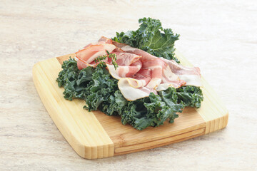 Raw pork bacon over board