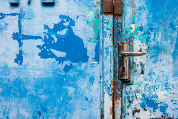 Background of old steel door lock with blue color painted.