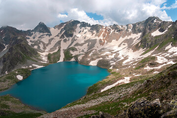 High-mountain lake Murudzhinskoye in the Teberda Biosphere Reserve with snow