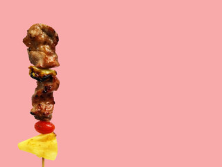 Thai street food fried skewer of pork and sauce with vegetables isolated on pastel color background and copy space for text concept for article and website and menu.