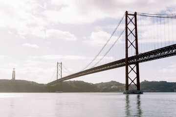 Landscape of the 25 April bridge and Christ the King statue in Lisbon, Portugal.