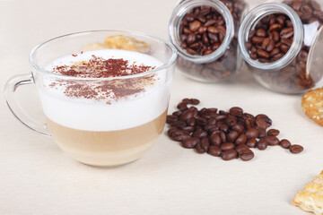 Still life with cappuccino, cookies, crackers and coffee beans on table.