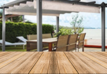 Wooden board empty table blurred background modern summer house gazebo terrace