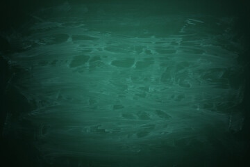 Dirty green chalkboard as background. Vignette effect