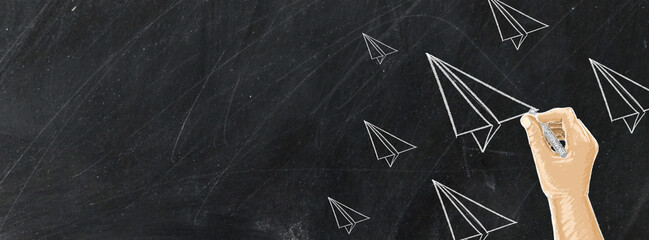 Hand drawing Rocket with chalk on blackboard,message concept written by chalk.
