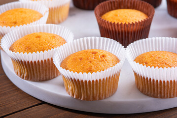 authentic homemade cupcakes on white marble board, sweet pastries