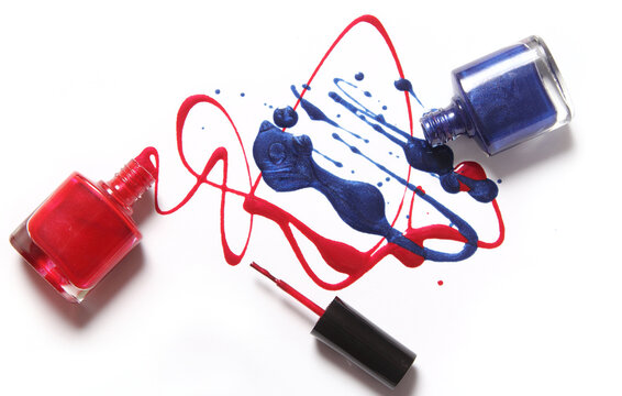 Red and Blue Spilled Nail Polish on White Background
