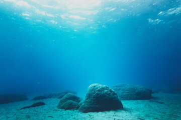 Underwater scene with rocks on sand