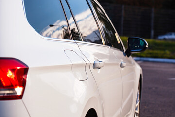 Right side of a white, modern car, close-up