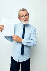 Photo of retired old man holding documents with a sheet of paper light background