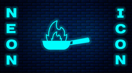 Glowing neon Pan with fire icon isolated on brick wall background. Vector