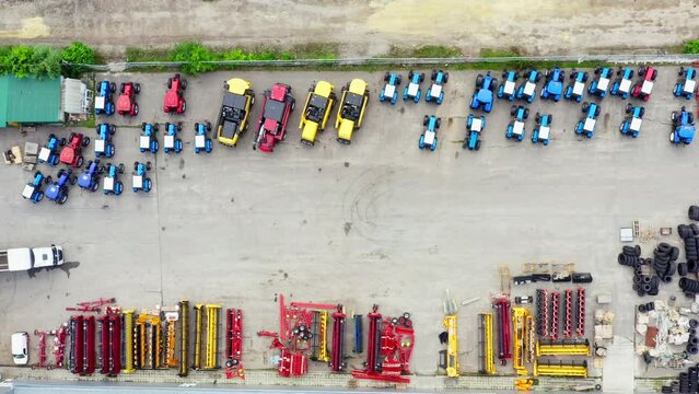 Agro Machinery and spare parts for agro-industry: tractors, plows, mowers, threshers, wheels and tires. Agricultural Machinery Spare Parts - aerial Drone Panorama shot.