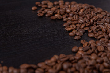 roasted coffee beans on black wood background