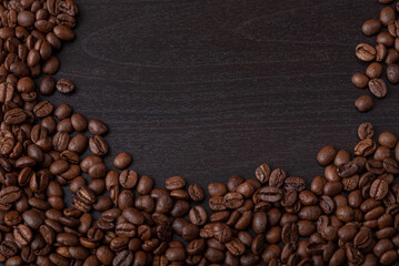 roasted coffee beans on black wood background