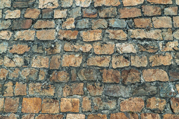 Texture of an ancient stone wall made of bricks