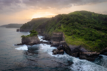 Soft sunset over a dramatic rocky coastline in the tropics of El Salvador