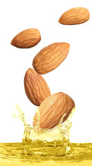 Tasty nuts falling into organic almond oil on white background. Vertical banner design