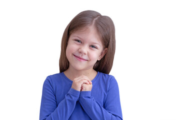 Smiling touched little girl holding hands on heart to show touchingness