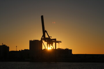crane silhouette sun set