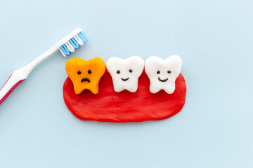 Oral health and care concept - clean teeth models with toothbrush