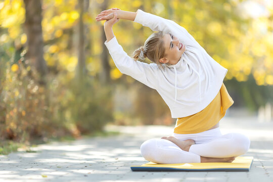 Woman practices yoga in the park. Girl in sports. High quality photo