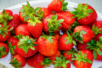 a plate full of fresh fruit red strawberry