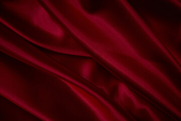 Naklejka na ściany i meble Beautiful draped silk fabric in red.