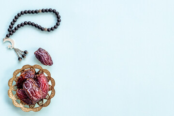 Ramadan concept. Black islamic rosary with crescent with dates fruits