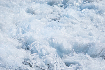 Melting ice floes in spring. A heap of blocks and fragments. Sunny day. Ice drift on the Amur River. Drifted ice pieces. Glare and shadows. © Алексей Игнатов