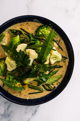 vegan green curry with broccoli cauliflower and green beans, healthy plant-based food
