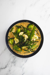 vegan green curry with broccoli cauliflower and green beans, healthy plant-based food