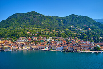 Fototapeta na wymiar Panoramic view of the historic part of Salò on Lake Garda Italy. Special View by Drone - Flying in Garda lake - Salò for an italian summer. Tourist on the lake.