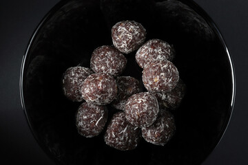 Cocoa balls with oatmeal covered with rasped coconut 