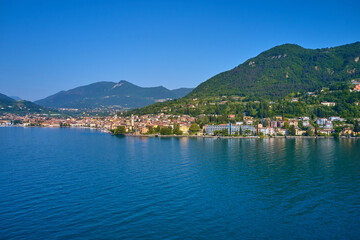 Fototapeta na wymiar Lake in the mountains of Italy. Aerial view of the town on Lake Garda. Panoramic view of the historic part of Salò on Lake Garda Italy. Tourist site on Lake Garda.