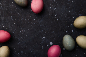 Dyed eggs on black background. Easter celebration concept