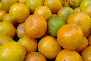 Tangerines from Thailand put together in heaps.