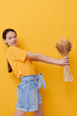 beautiful girl in a yellow t-shirt flax bouquet emotions summer style Lifestyle unaltered