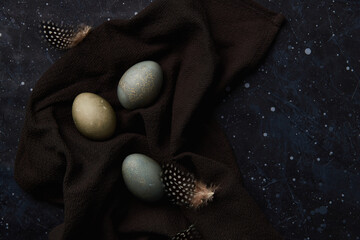 Dyed eggs on black background. Easter celebration concept