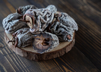 Dried persimmon on a wooden background. Healthy diet