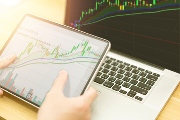 graph in computer and mobile show finance business and stock market volatility