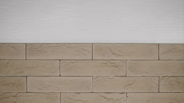 vintage brick background. artificial stone imitating neat brickwork. clinker tiles for home renovation. construction and facing materials. Stop motion.
